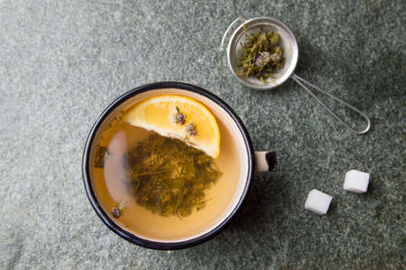 Wild thyme herbal tea with lemon in a cupの写真素材