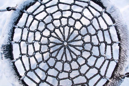 Top view up of a frozen swing seat texture in the parkの写真素材