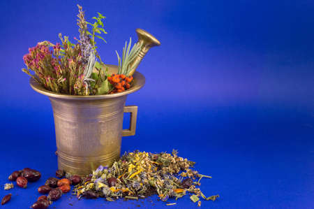 Dried herbs in a golden vintage mortarの写真素材