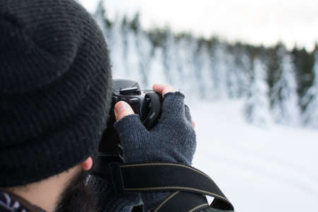 Photographer taking picture of a winter sceneryの写真素材