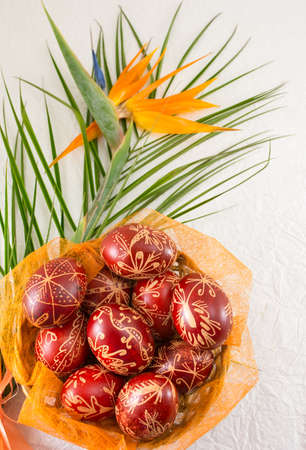 Easter eggs decorated with wax and orange flower