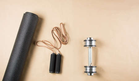 Yoga mat with dumbbell and leather jumping ropeの写真素材