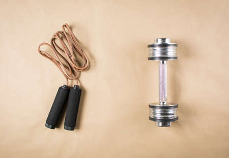 Leather jumping rope and a dumbbell. Workout timeの写真素材