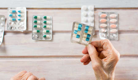 Senior woman hands picking her today medical pillsの写真素材