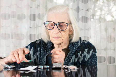 Senior woman determining her today medical therapyの写真素材