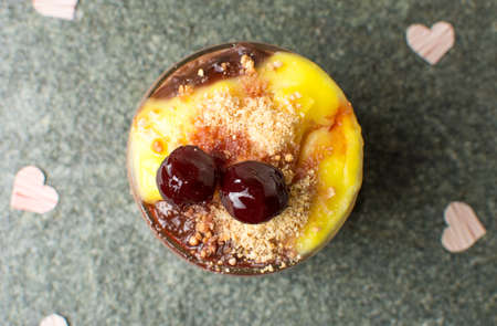 Homemade pudding mix of vanilla and chocolate with cherryの写真素材