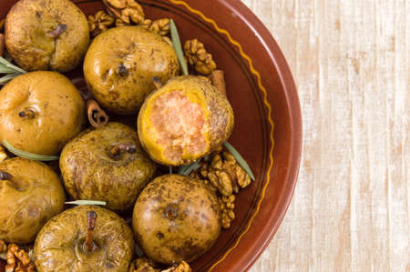 boiled wild pears with walnuts and cinnamon on a plateの写真素材
