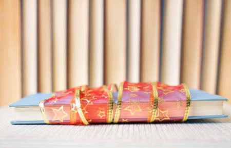 Blue book as a present with ribbonの写真素材