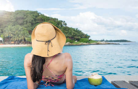 Girl with coconut on a tropical destinationの写真素材