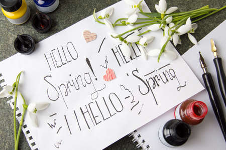 Hello spring calligraphy note with fresh snowdropsの写真素材