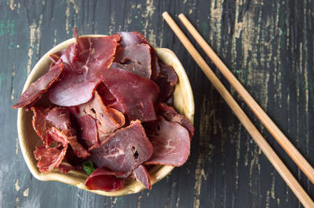 Smoked prosciutto ham in a bowl with chopsticksの写真素材