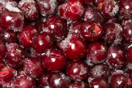 Frozen cherry fruit on a pile backgroundの写真素材