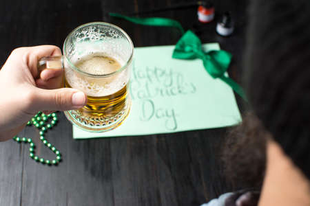 Man drinking beer and celebrating St Patrick day  close upの写真素材
