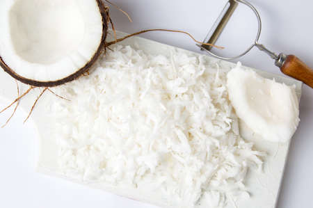 Grated coconut fruit on a wooden board