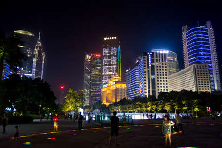 GUANGZHOU, CHINA - SEPTEMBER 13, 2016: Guangzhou modern central city district with people walking in illuminated path, night viewのeditorial素材