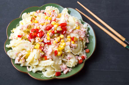 Creste di gallo pasta with vegetables on a plateの写真素材