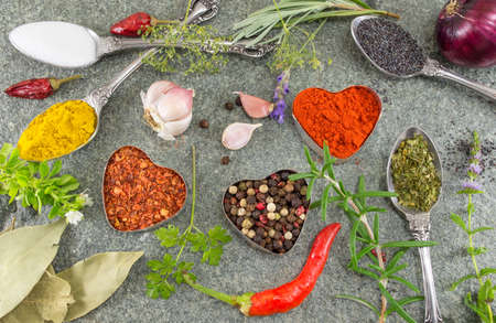 Bunch of spices and vegetables on stone background flatlayの写真素材