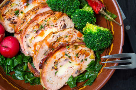 Rolled meat with vegetables in a bowlの写真素材