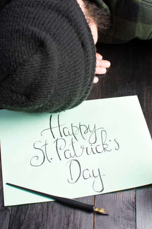 Man sleeping on a table during St Patricks day celebrationの写真素材