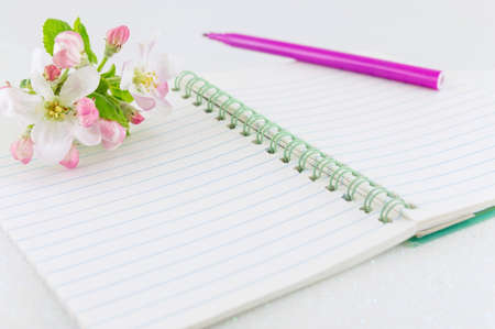 Open notebook with apple tree blossom flowersの写真素材