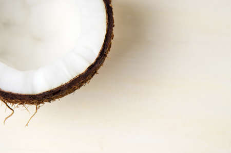 Halved coconut fruit on a wooden tableの写真素材