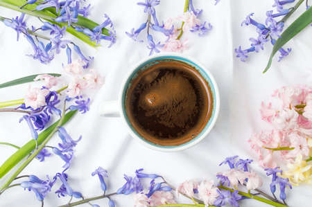 Cup of coffee and colorful hyacinth flowersの写真素材
