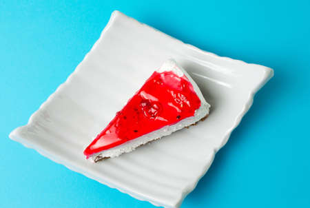 strawberry cheesecake slice on a white plateの写真素材