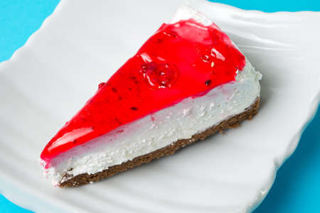 strawberry cheesecake slice on a white plateの写真素材
