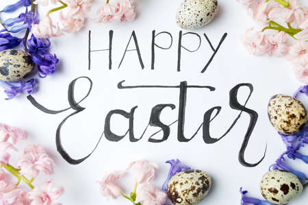 Handwritten Happy Easter note on white paperの写真素材