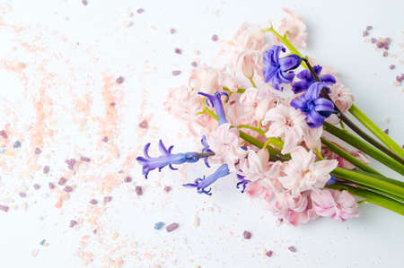 Hyacinth flowers bouquet and pink bath saltの写真素材