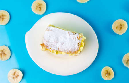 Banana cake in a plate on blue backgroundの写真素材