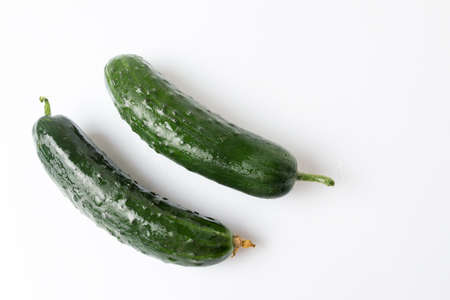 Fresh washed cucumbers on white wooden tableの写真素材