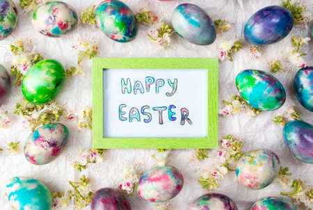 Happy Easter card with painted eggs and chestnut blossom flowersの写真素材