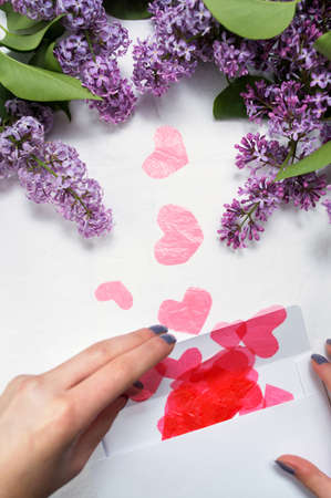 Girl opening letter full of red heartsの写真素材