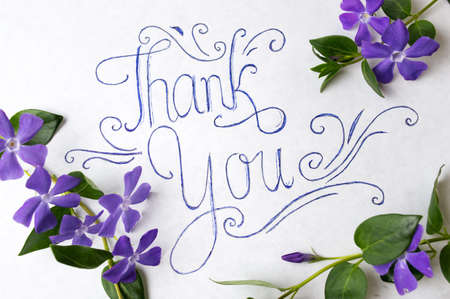 Thank you note surrounded by purple spring flowersの写真素材