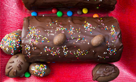 Homemade chocolate cake with candy eggs on a tray