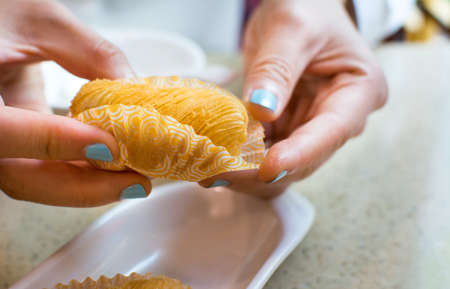 Girl hands holding crispy durian fruit dessertの写真素材