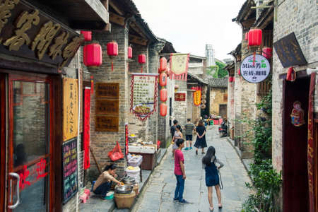 HUZHOU, CHINA - MAY 2, 2017: Tourists walking in the Huang Yao Ancient Town in Zhaoping county, Guangxi province. Traditional Chinese strry styleのeditorial素材