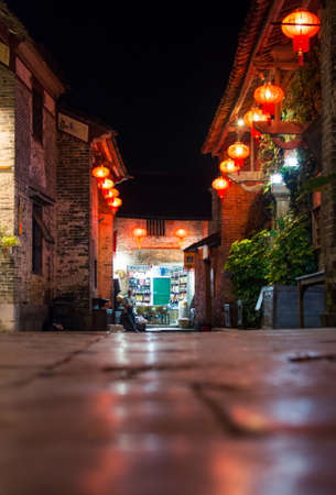 HUZHOU, CHINA - MAY 2, 2017: Huang Yao Ancient Town street in Zhaoping county, Guangxi province. Night view of traditional Chinese town architecture with lanternsのeditorial素材