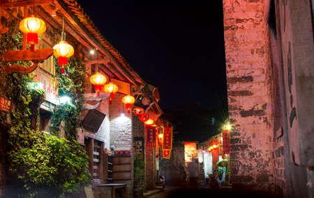 HUZHOU, CHINA - MAY 2, 2017: Huang Yao Ancient Town street in Zhaoping county, Guangxi province. Night view of traditional Chinese town architecture with lanternsのeditorial素材