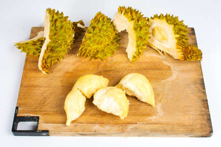 Peeled durian  fruit with peel on a wooden boardの写真素材