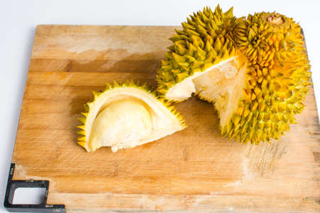 Durian fruit slice with peel on a wooden boardの写真素材