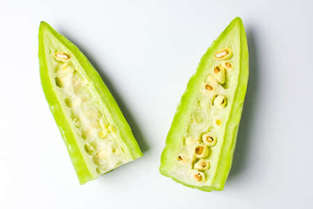 Sliced bitter melon gourd on white backgroundの写真素材