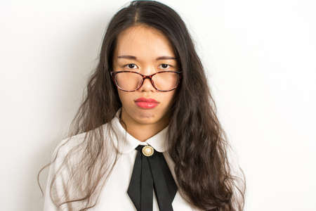 Tired young asian business woman with glassesの写真素材