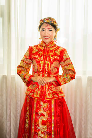 Chinese bride in traditional red wedding dress portraitの写真素材