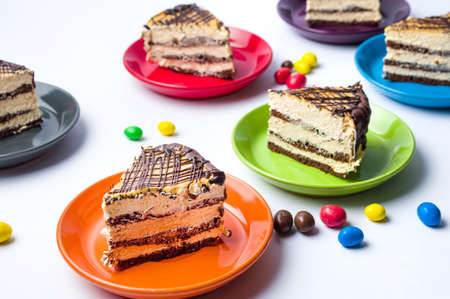 Caramel cake slices served on colorful platesの写真素材