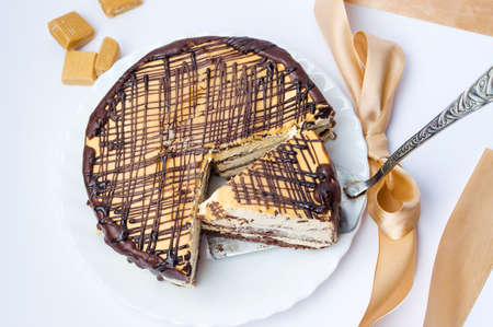 Caramel cake with triangle shaped slice cut outの写真素材