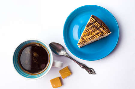Caramel chocolate cake and a cup of coffeeの写真素材