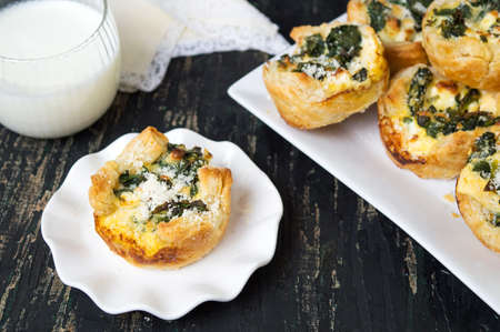 Homemade spinach pie with yogurt on a tableの写真素材