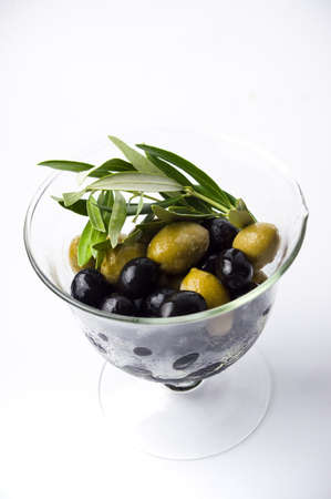 Mixed olives in the glass jar isolatedの写真素材